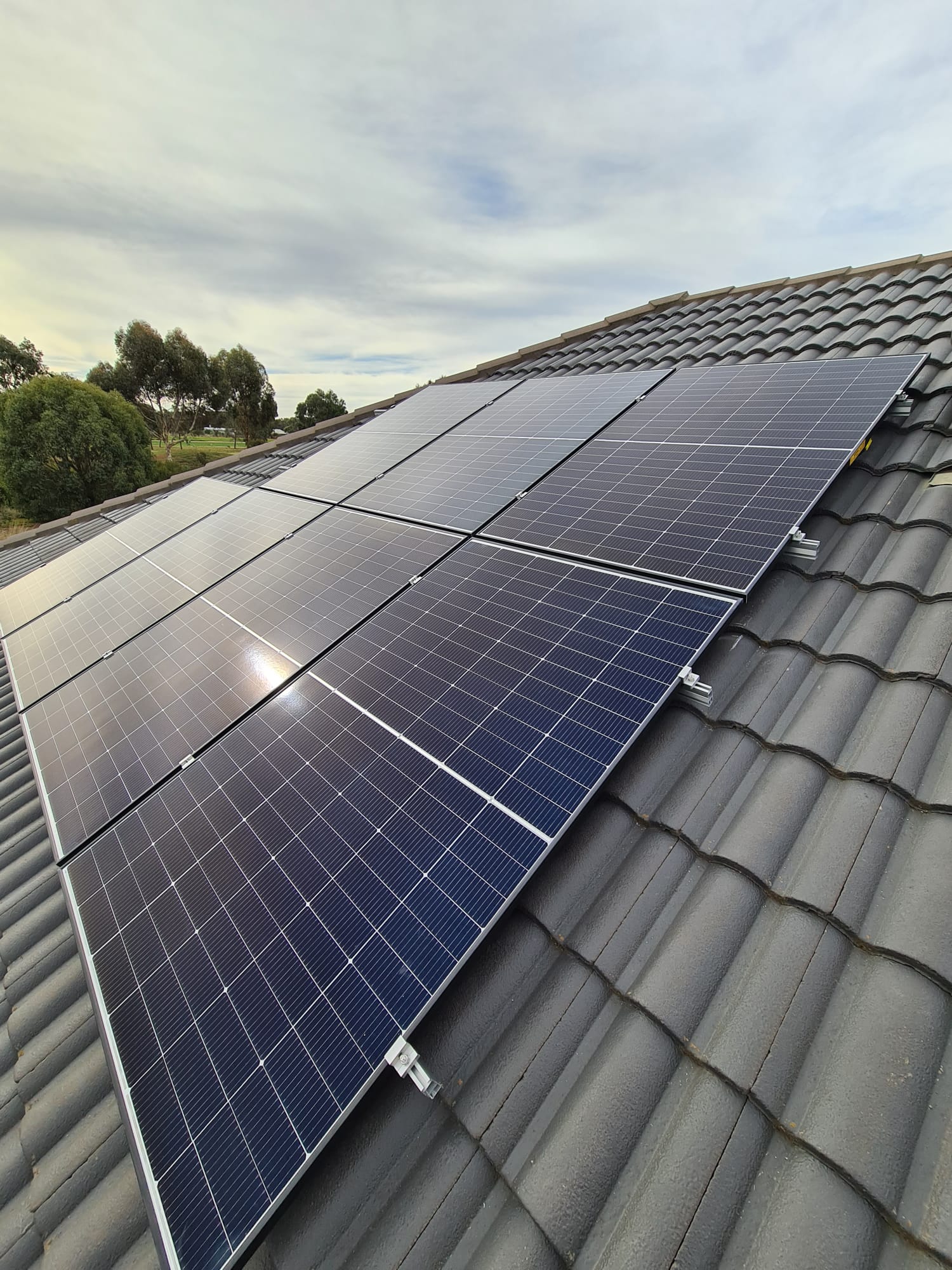 Solar panels installed across a grey tiled roof